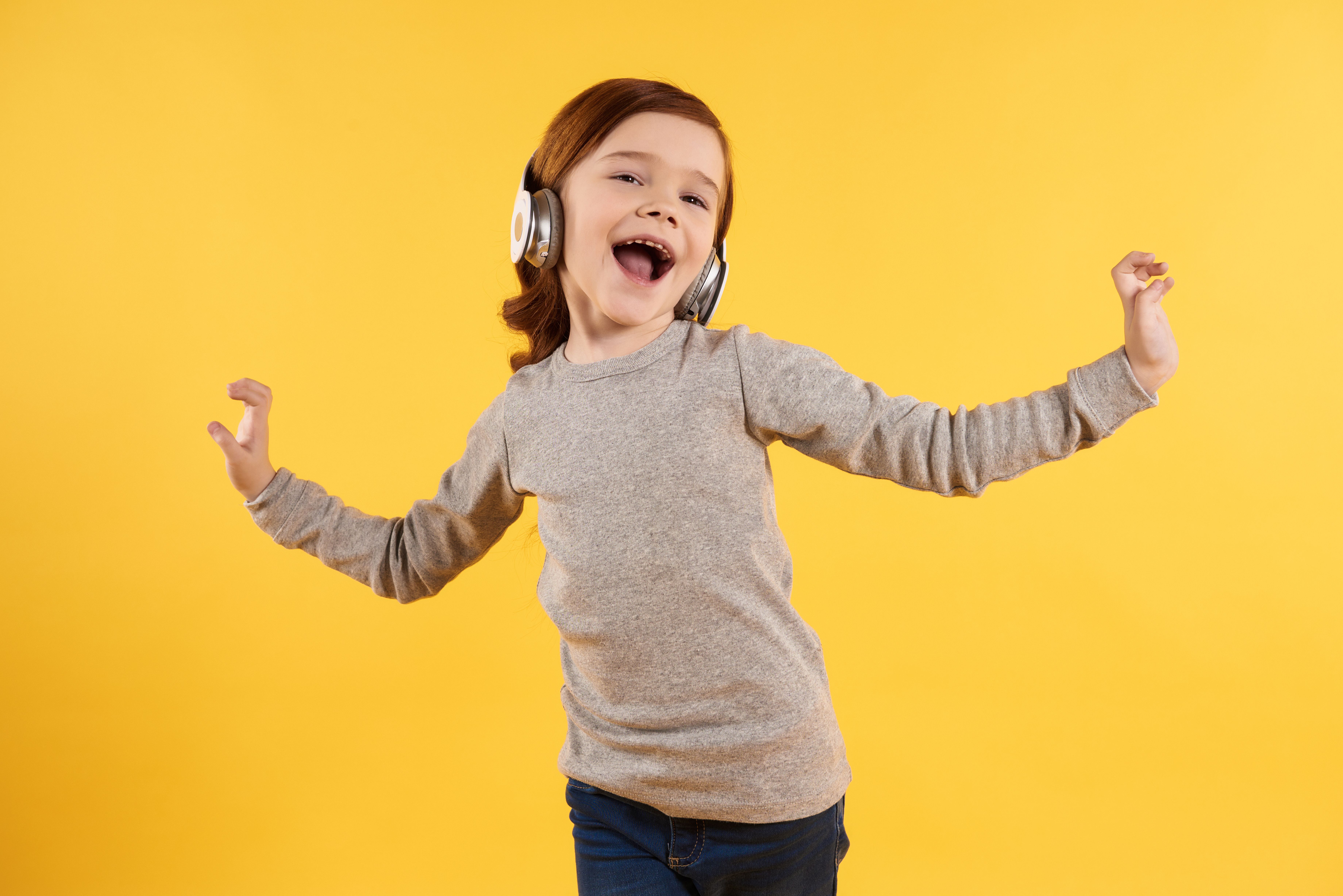 cheerful-girl-with-headphones-listening-music.jpg